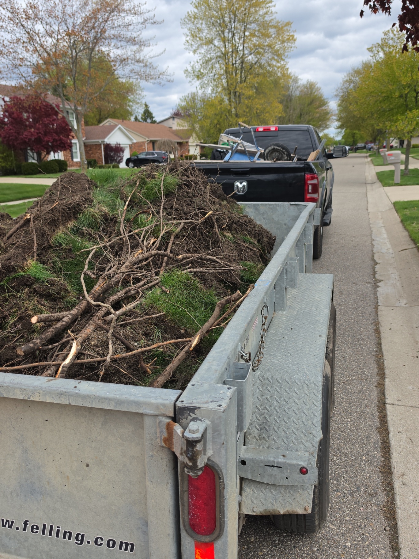 Trailer loaded with removed sod, roots, and yard debris after cleanup