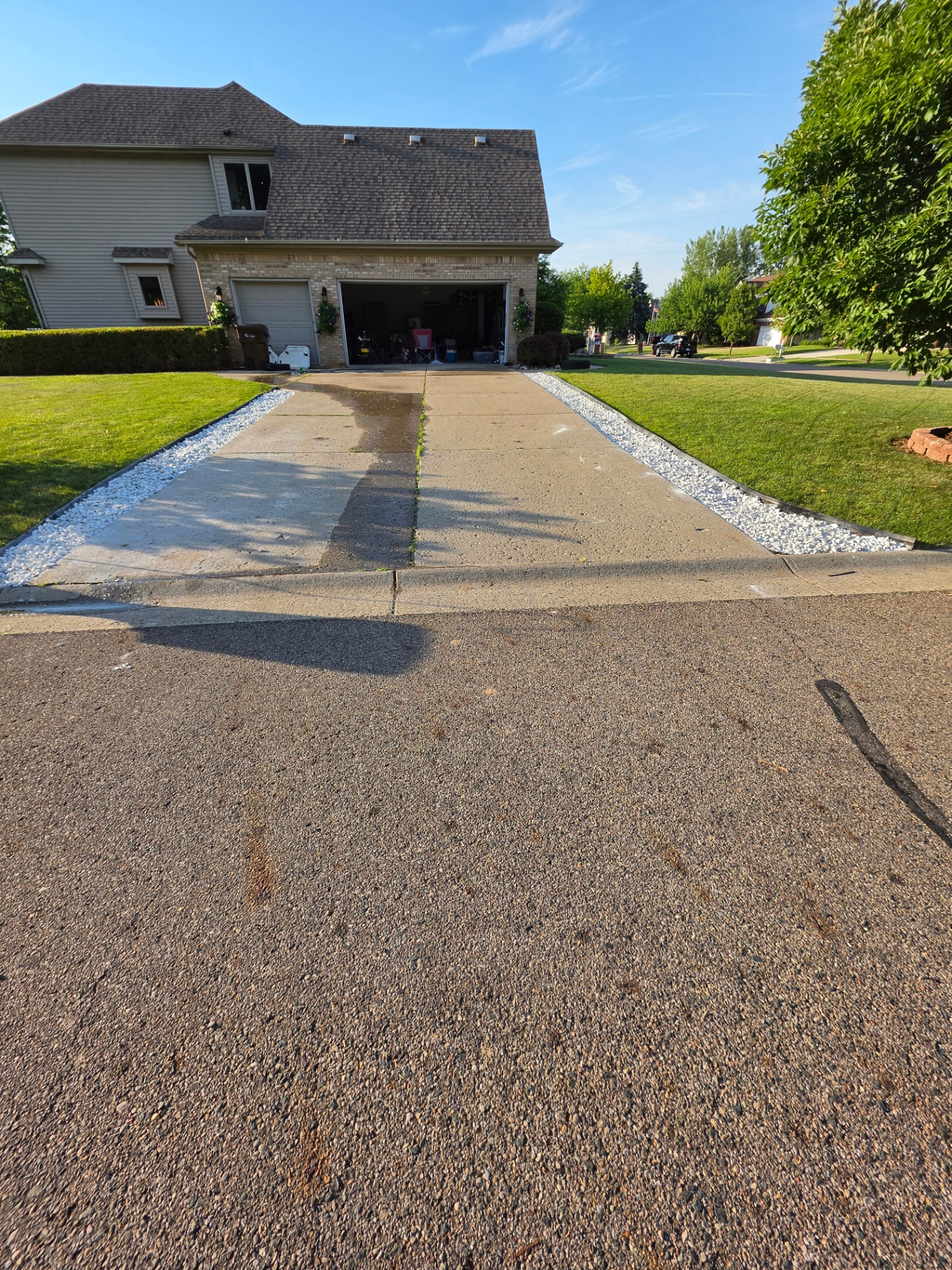 Same driveway after install with crisp white stone borders along both sides
