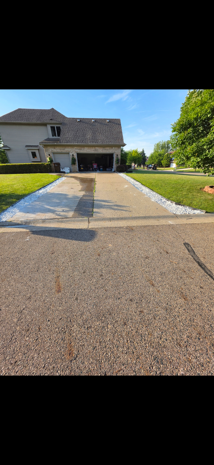 Clean driveway with fresh white stone edging on both sides